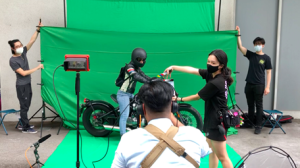 Behind-the-scenes set up of the green screen and the working team in action.